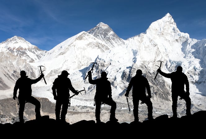 Mount Everest and silhouette of climbing men